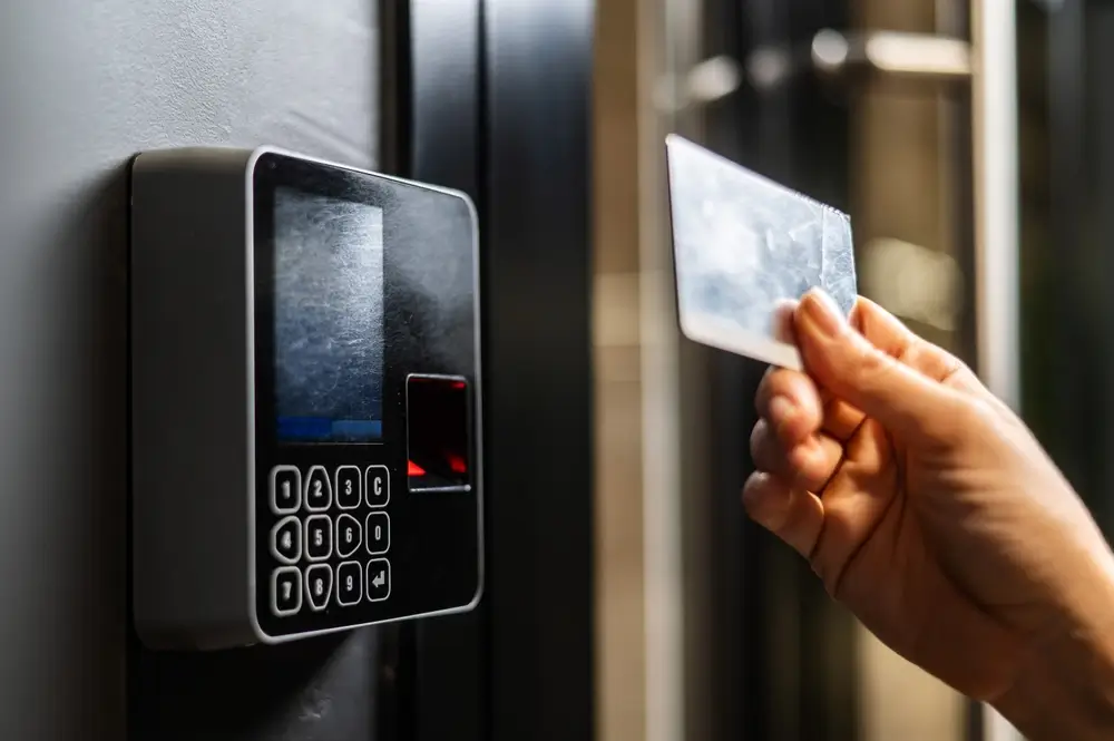 Ecamsecurity Access Control Systems for Enhanced Security and Restricted Entry Hand holding a keycard near an access control panel, representing Ecamsecurity’s secure access solutions.