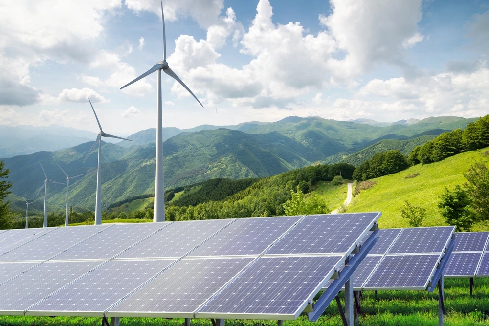 Ecamsecurity Surveillance Solutions for Renewable Energy Sites Solar panels and wind turbines in a green landscape, suitable for Ecamsecurity’s remote energy site monitoring solutions.